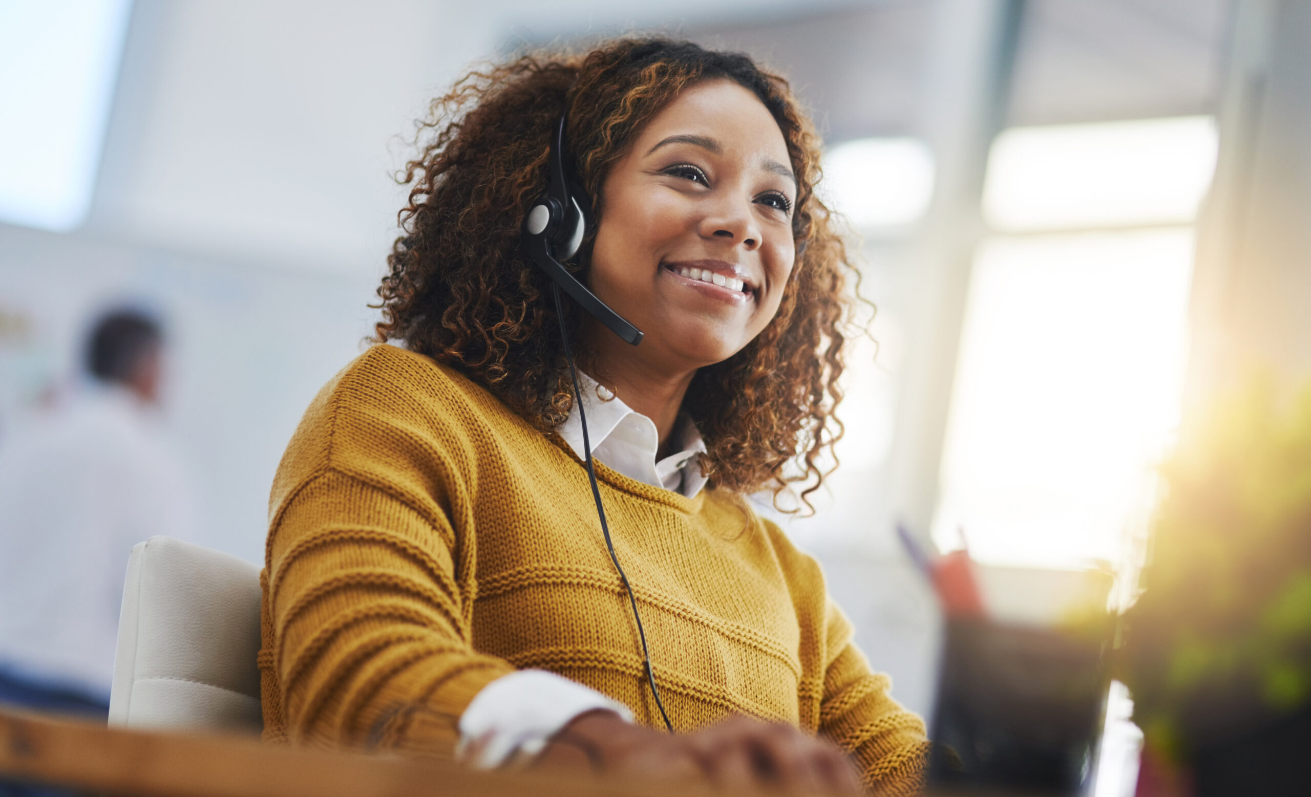 African woman, call center agent or smile with voip for consulting, listening or contact us in office. Female consultant, customer service or tech support crm with headphones, microphone or help desk